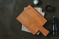 Wood cutting board over towel on stone kitchen table Royalty Free Stock Photo