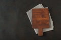 Wood cutting board over towel on stone kitchen table Royalty Free Stock Photo