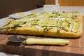 Wood cutting board with pizza and knife Royalty Free Stock Photo