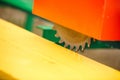 Wood cutting machine. Close up electric circular saw cutting wood and iron ruler Royalty Free Stock Photo