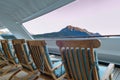 Wood deck lounge chairs at sunrise, stern verandah of cruise ship, Skagway, AK. Royalty Free Stock Photo