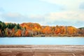 Wood deck overlooking fall colored landscape and lake Royalty Free Stock Photo