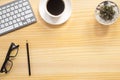 wood desk office with laptop, smartphone and other work supplies with cup of coffee. Top view with copy space for input the text. Royalty Free Stock Photo