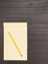 Wood Desk, Yellow Notepad, Pencil