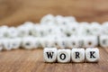 Wood dice with word WORK on dice