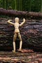 Wood doll climbing a tree Royalty Free Stock Photo