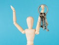 Wood doll holding set of retro keys Royalty Free Stock Photo