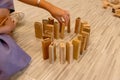 Wood domino lined up by a man`s hand Royalty Free Stock Photo