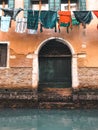 Wood door and window. On redbrick wall, building facade in Venice, exterior design
