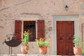 Wood door and windows with wooden shutters on pink colored wall in Greece Royalty Free Stock Photo