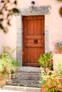 Wood door and windows with wooden shutters on pink colored wall Royalty Free Stock Photo