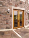 Wood doors by a stone building