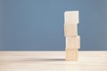 wood empty four blocks stack on table and blue blackground with copy space for text or symbols, development concept for growth Royalty Free Stock Photo