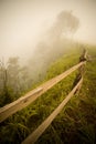 Wood fence on the cliff with fog