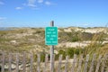 wood fence and sand dunes at the beach with please keep off sign Royalty Free Stock Photo