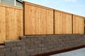 Wood Fence on Stone Retaining Wall on Side of Home