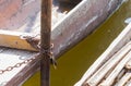 Wood Fishing Boat is Enchained by Iron Chain with Wood Boat Pole Royalty Free Stock Photo