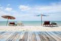 wood floor on beach chairs and colorful umbrella on tropical beach,blue sky and cloud background,beautiful scenery background. Royalty Free Stock Photo