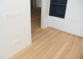 Wood flooring with modern wooden wall as interior room design, wall sockets, outlets