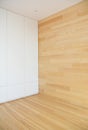 Wood Flooring with modern wooden wall as interior room design and white hidden wardrobe.