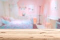 Wood foreground with blur pink lovely bedroom