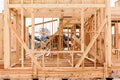 Wood-frame house under construction, window frame and wall details