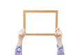 Wood frame for photo in the hands of a girl. Close-up. White isolate Royalty Free Stock Photo