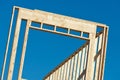 Wood frame residential building under construction new home currently under construction against blue sky Royalty Free Stock Photo