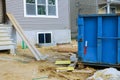 Wood frame structure of house under construction on construction building from beam construction materials in a dumpsters Royalty Free Stock Photo