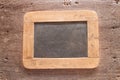 Wood framed chalkboard over old wood background. Vintage style Royalty Free Stock Photo