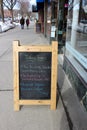 Large wood framed chalkboards line the streets of downtown area, advertising sales for people passing by, saratoga, New York, 2019