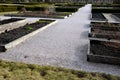 Wood framed herb beds in the monastery garden castle. rectangular flower bed with herbs and park paths of bright colors. Maintaine