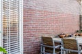 Wood garden table with brick wall