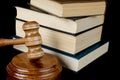 Wood gavel, soundblock and stack of thick old books Royalty Free Stock Photo