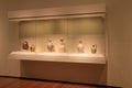 Wood and glass cabinet with exhibit of historic pottery, Cleveland Art Museum, Ohio, 2016