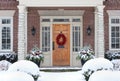 Wood grain front door of house with colorful Christmas wreath Royalty Free Stock Photo