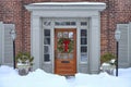 Wood grain front door with traditional Christmas wreath Royalty Free Stock Photo