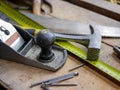 Wood hand plane, yellow tape measurer, wood saw, hammer and nails Royalty Free Stock Photo