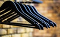 Wood hangers coat. Many wooden black hangers on a rod. Store concept, sale, design, empty hangers. Wooden coat hanger Royalty Free Stock Photo