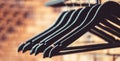 Wood hangers coat. Many wooden black hangers on a rod. Store concept, sale, design, empty hangers. Wooden coat hanger Royalty Free Stock Photo