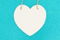 Wood heart on bright teal glitter background