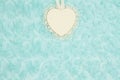 Wood heart with lace on pale teal rose plush fabric background