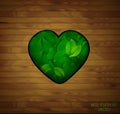 Wood heart, love for natural material concept, green heart full of leaves in the wooden floor,