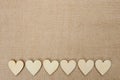 Wood hearts on hessian texture background, valentine background Royalty Free Stock Photo