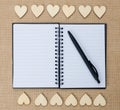 Wood hearts on hessian texture background, valentine background. Royalty Free Stock Photo