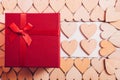 Wood hearts and red gift box on white wooden background Royalty Free Stock Photo