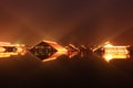 Wood house built on water at night