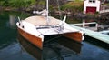 Wood hull catamaran sailboat tied to a dock Royalty Free Stock Photo