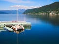 Wood hull catamaran sailboat tied to a dock on the Sognefjord in Norway Royalty Free Stock Photo