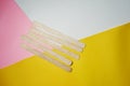 Wood ice-cream stick isolated on Yellow, pink and white background Royalty Free Stock Photo